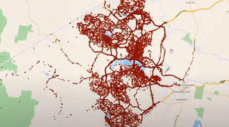 A screencap from the featured video showing a concentration map of a sparsely-populated region in red points on a beige background