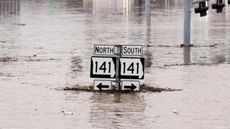 Highway sign in Missouri reading 141 North and South almost completely underwater in a flood