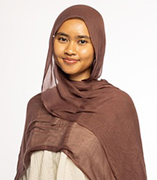 Maryam smiling in front of a white background 