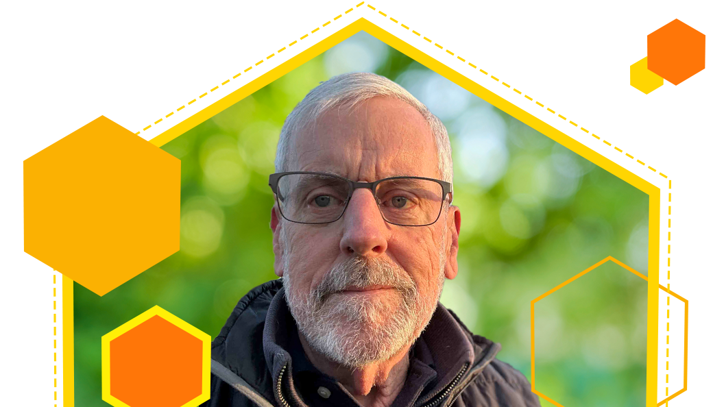 Allen Carroll wearing glasses and standing outside surrounded by orange and yellow graphic elements