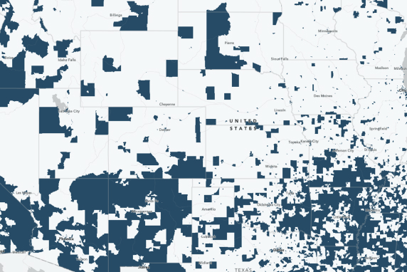 A white and blue map displays the locations of disadvantaged communities in the United States
