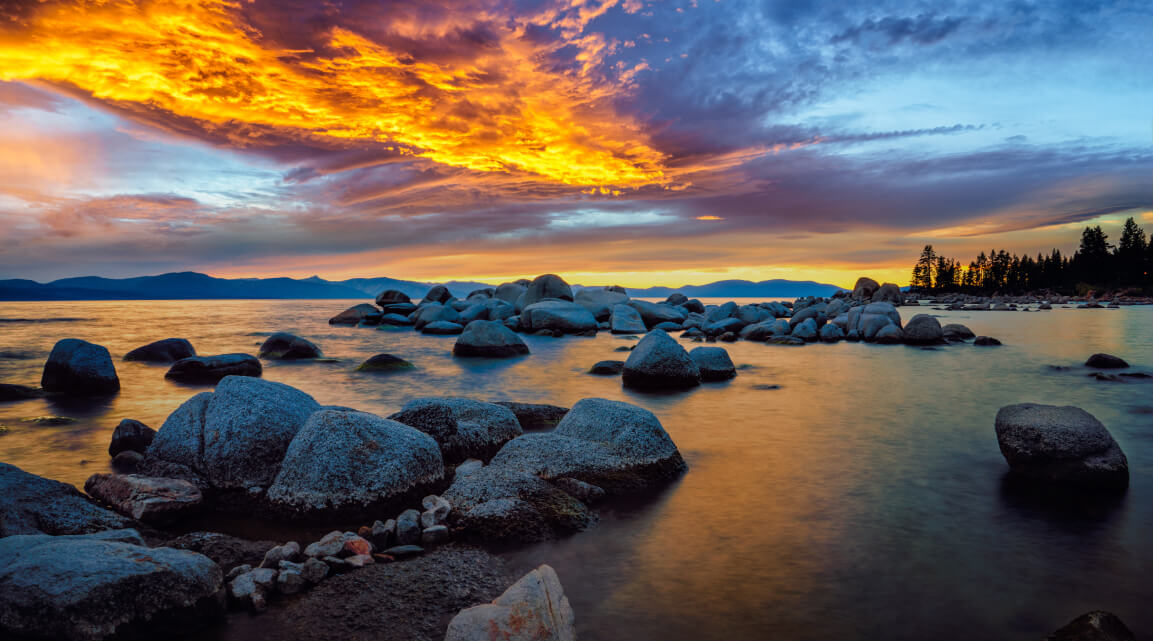 A rocky shore in lake Tahoe at sunset