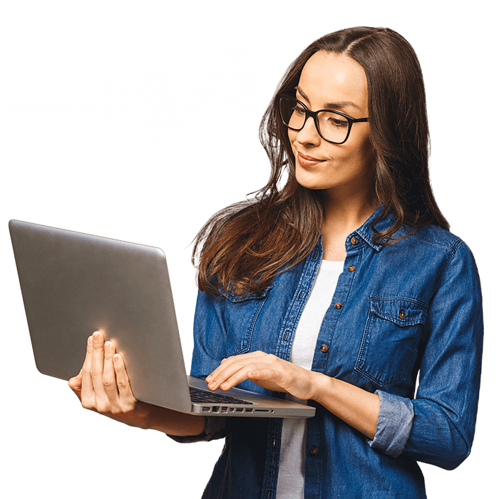 Person wearing glasses looking at a laptop computer where they can watch videos from the Esri User Conference.