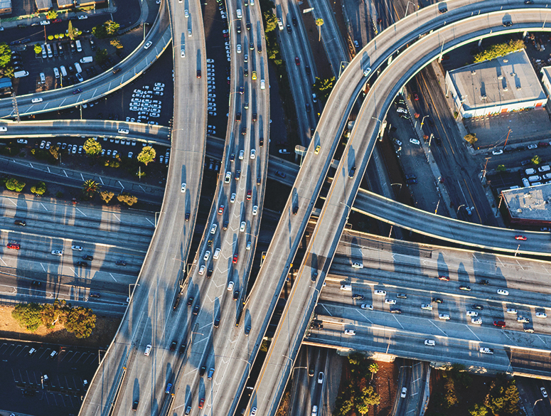 An intricate highway junction dotted with cars