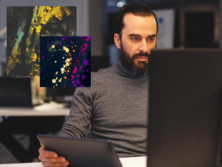 A person using a desktop computer overlaid with two colorful maps