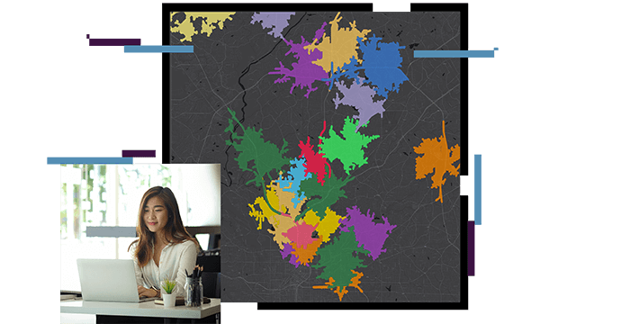 Woman sitting at desk looking at a computer, map with colorful areas