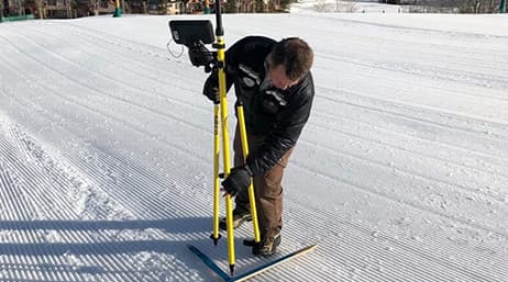 Mike Krois, Vail Ski Resort GIS analyst, using a GPS unit on the snow to record accurate measurements for Vail’s digital twin