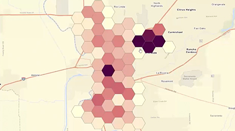 A map overlaid with hexagonal tiles shaded in a pink-to-purple color gradient