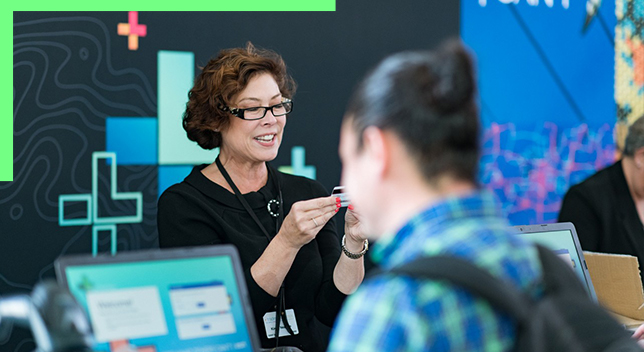 Woman helping attendees at the Esri User Conference