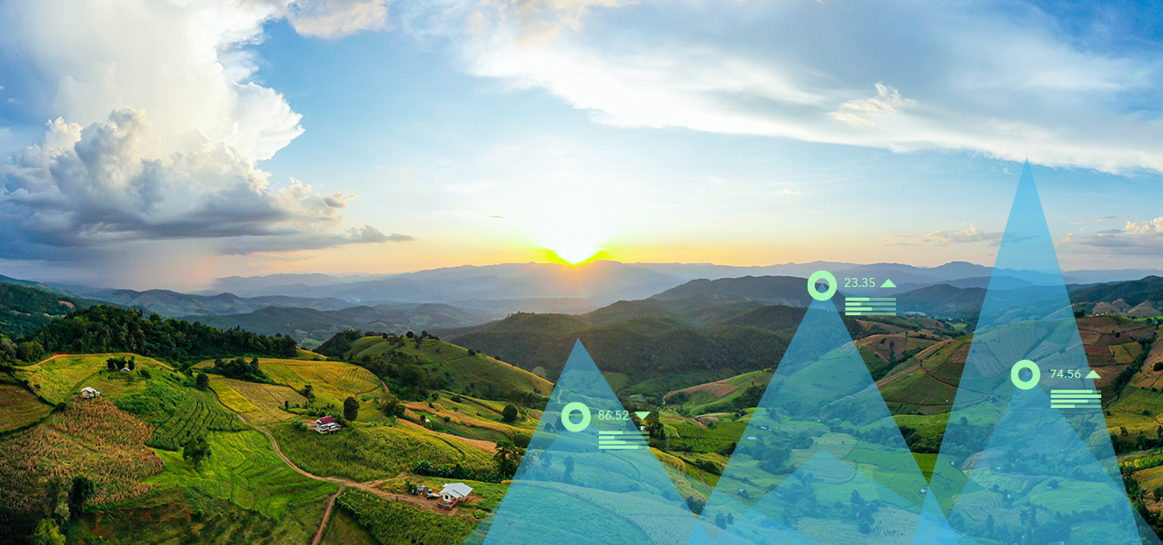 Paisaje de montañas verdes con dos gráficos triangulares en la parte superior