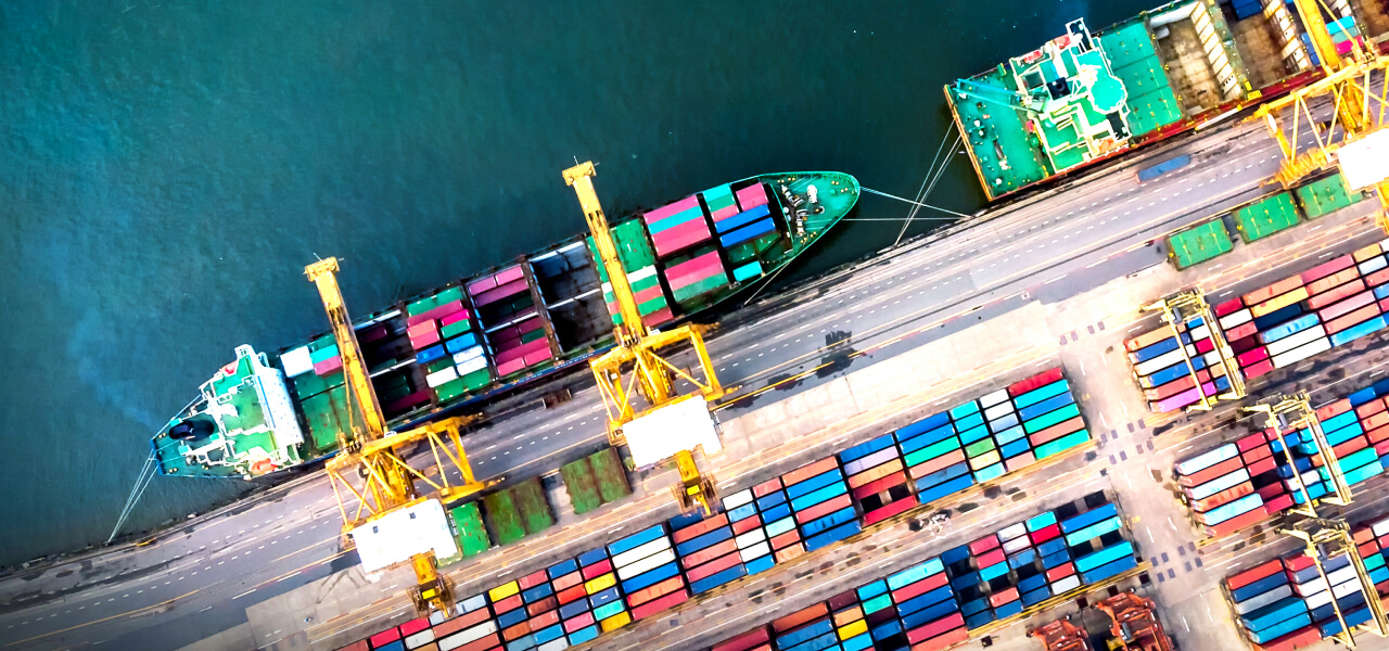 An aerial view of two ships docked at a port