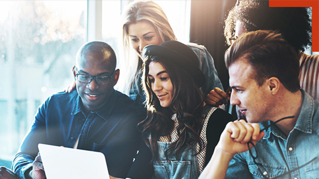 A diverse group of individuals fascinated by the contents displayed on a laptop.