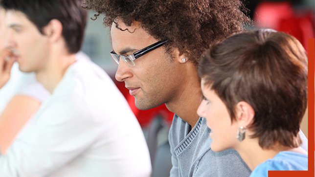 man in glasses sitting next to a woman