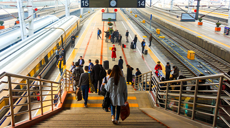 High angle view of passengers walking down to a passenger train platform