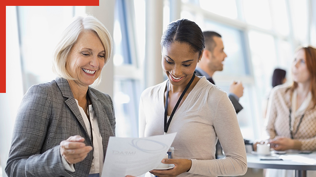 Two women reviewing document in office