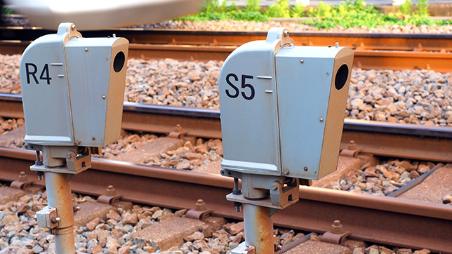 Two small sensor boxes, labeled R4 and S5 respectively, alongside a rail bed