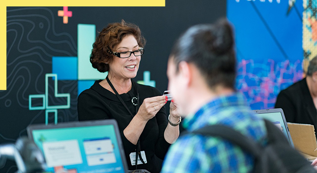 A presenter leading a GIS tutorial at a conference