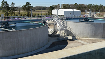 Two large, circular water reservoirs at a water treatment facility