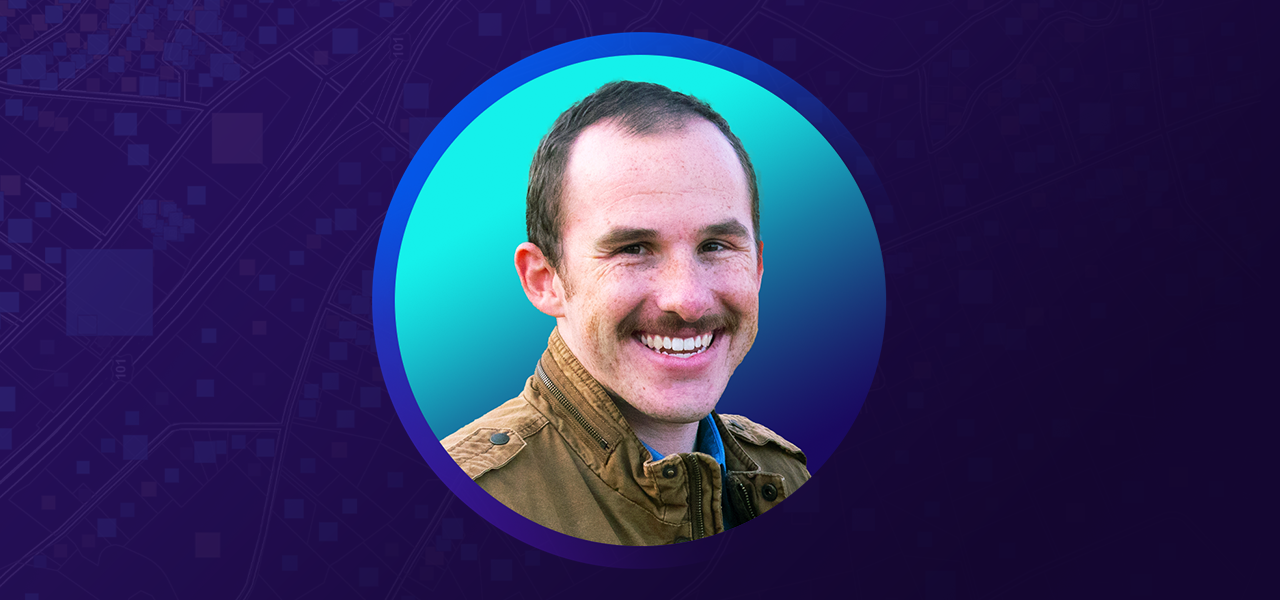 Sean Quarnstrom smiling and wearing a jacket overlaid on a blue and purple graphic background