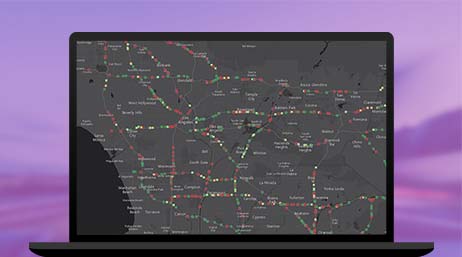 A graphic of a laptop monitor displaying multicolored points on a black and gray route map on a purple background