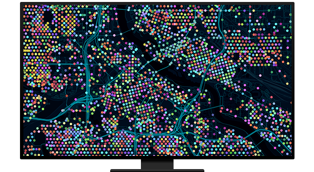 Graphic of a computer monitor displaying a city map with blue streets and many colorful points on a black background