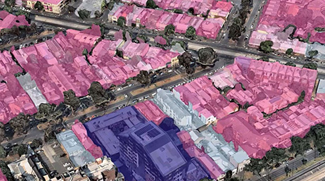 A neighborhood with houses highlighted pink and white, and a large building highlighted purple