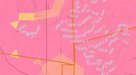 A pink model of a wind farm with locations of turbines and areas marked with yellow