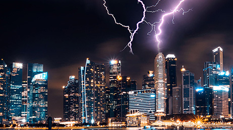 A skyscraper being struck by lightning