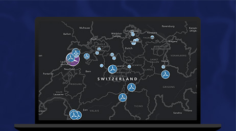 A dark map with blue clusters identifying locations displayed on a laptop