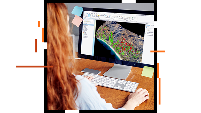 A person using GIS software on a desktop computer