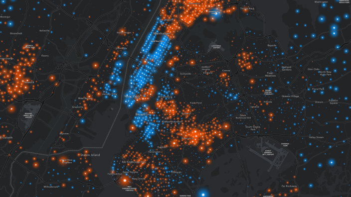 A heat map of a large city with glowing red and blue points scattered over a dark gray background