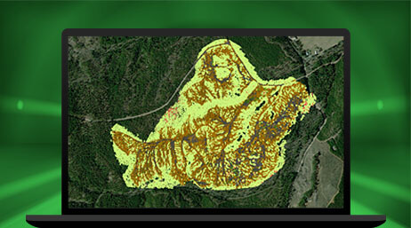 A graphic of a laptop monitor displaying a contour map of a dark green forest with an asymmetrical area highlighted in yellow