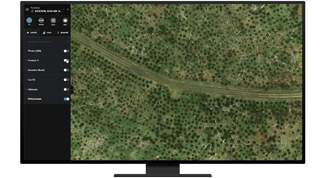 A graphic of a computer monitor displaying an aerial view of a green and brown forest with a road through the middle with an analysis legend on the side
