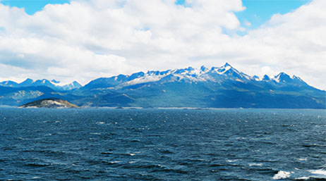 A view of the ocean with mountains in the background