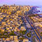 An aerial photo of a seaside city surrounded by suburbs with buildings reflecting the warm golden yellow light of the sunrise beneath a hazy pale sky beside a vivid blue and violet ocean
