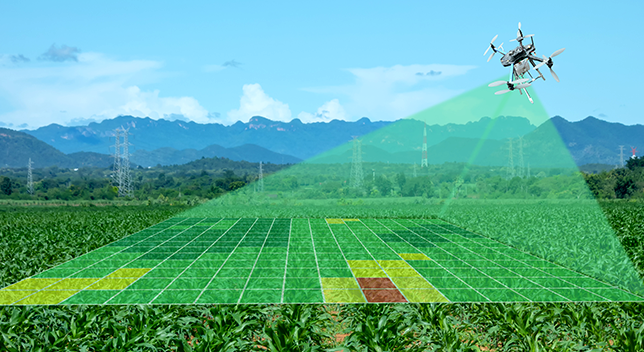 A composite photo of green sunny farmland with blue mountains in the distance, with an overlaid heat map grid being projected by a drone overhead