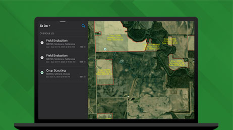 Graphic of a laptop monitor displaying a map dashboard with an aerial photo of farmland alongside related data