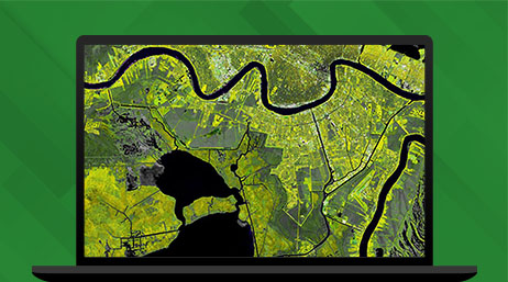 Graphic of a laptop monitor displaying a map of green farmland and rivers on a green background