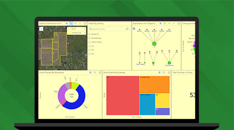 Graphic of a laptop monitor displaying a map dashboard with a map of farmland and several graphs on a green background