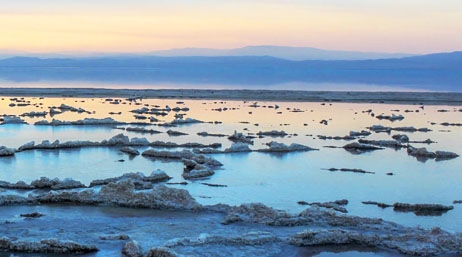 A landscape of salt flat with pools of water