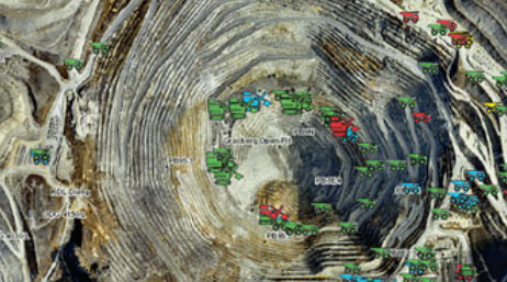A quarry with illustrated green red and yellow construction trucks showing the efficiency of each location