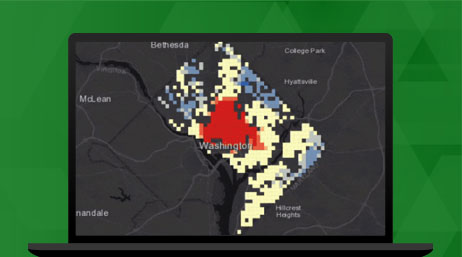 A laptop displaying a map with pixilated red, blue, and light-yellow sections in Washington illustrating a feature in ArcGIS Velocity that shows monitoring of assets and predictive maintenance.