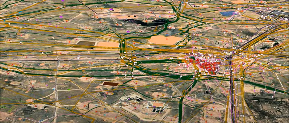 An aerial photo of a city surrounded by rural land in green and brown, overlaid with a highlighted network of highways and clustered map points