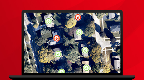 A graphic of a laptop monitor displaying an aerial photo of a suburban neighborhood with fire safety icons overlaid on each house