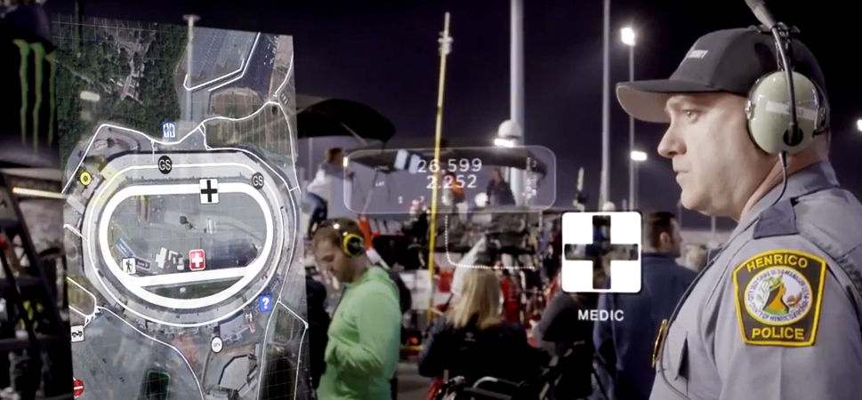 A screencap from the featured video, showing a street crowded with civilians and uniformed responders wearing headsets at night