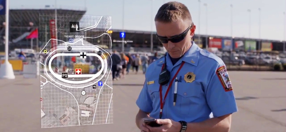 Public safety staff member looking at smart phone in his hand