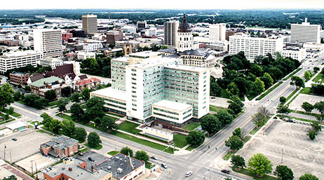 An aerial view of Topeka with buildings, roads, and trees