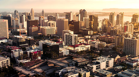An aerial view of San Diego with a sunset in the background