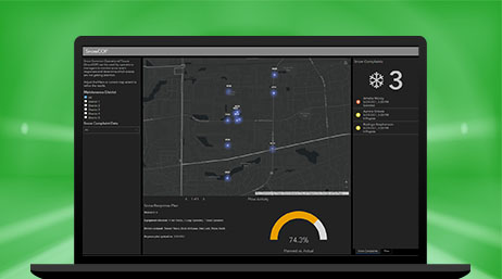 A laptop displaying a dashboard of solutions to manage snow operations with maps, graphs, and more information