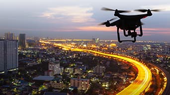 An aerial view of a drone overlooking a city and a large freeway